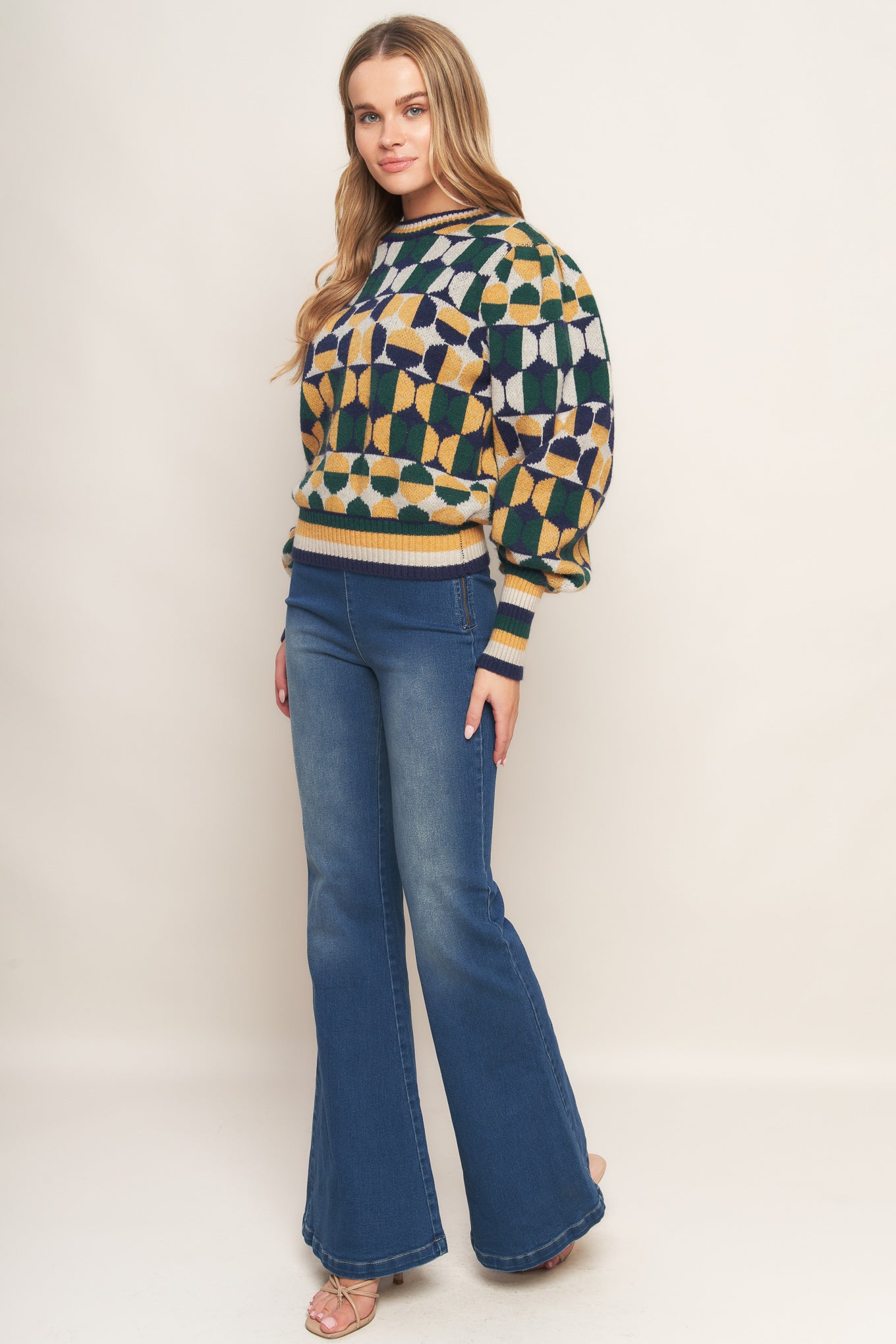A jacquard knit sweater with a high neckline and long-sleeve