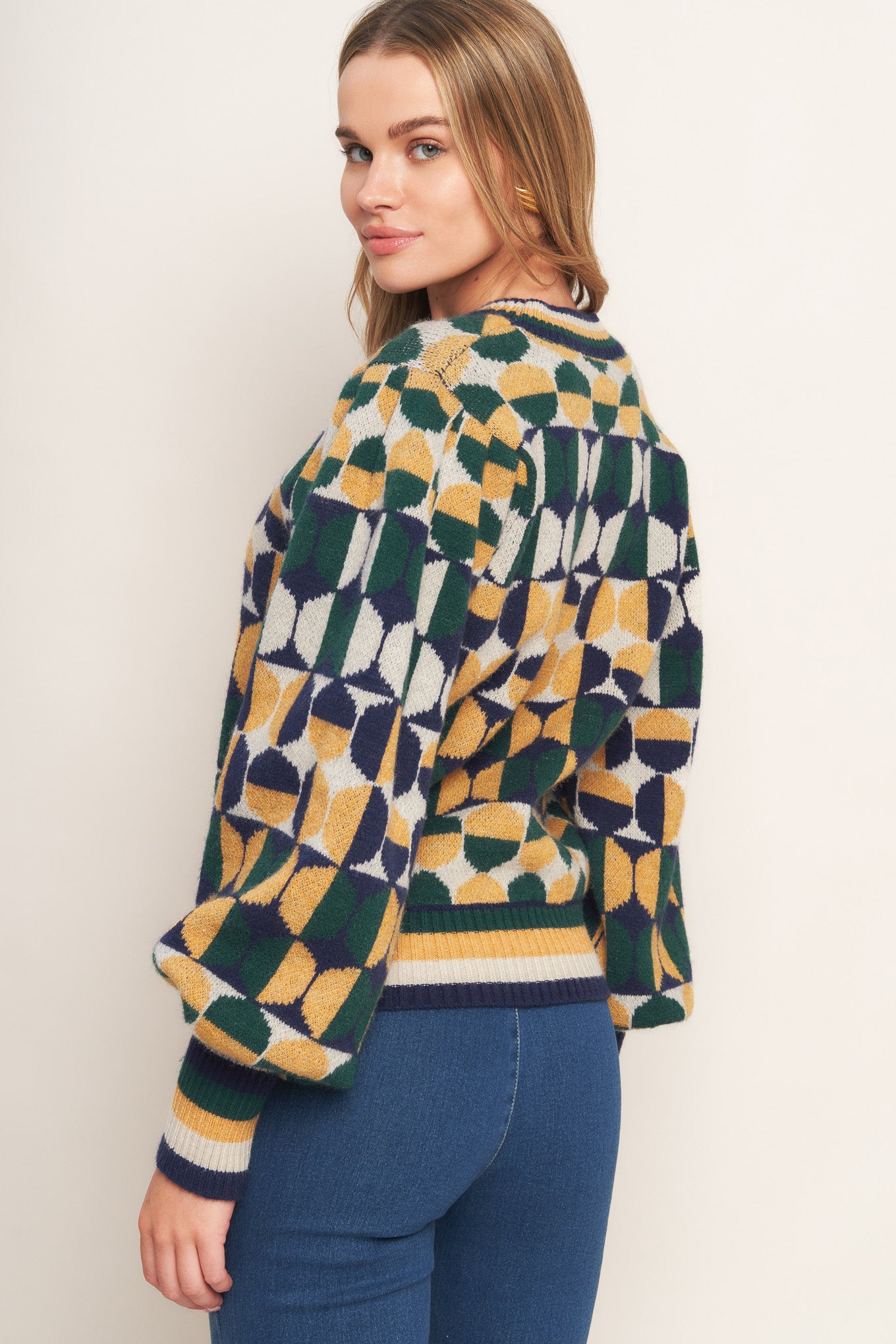 A jacquard knit sweater with a high neckline and long-sleeve