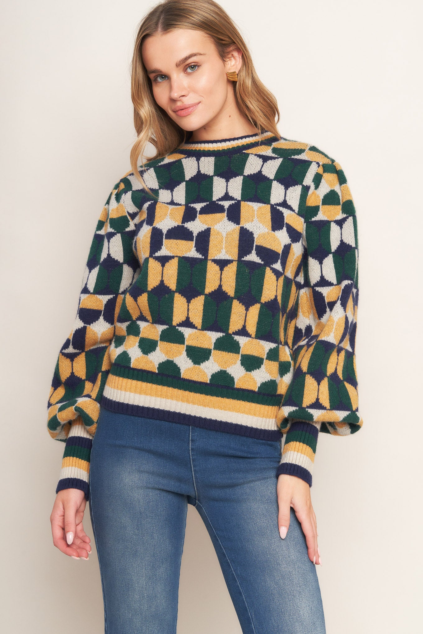 A jacquard knit sweater with a high neckline and long-sleeve
