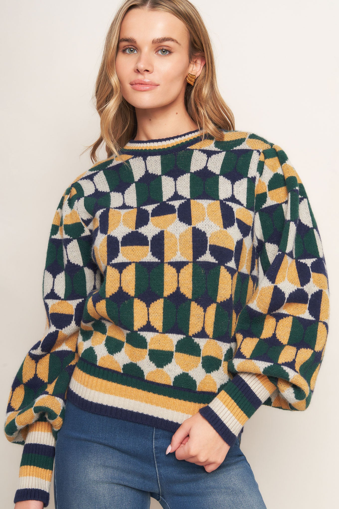 A jacquard knit sweater with a high neckline and long-sleeve