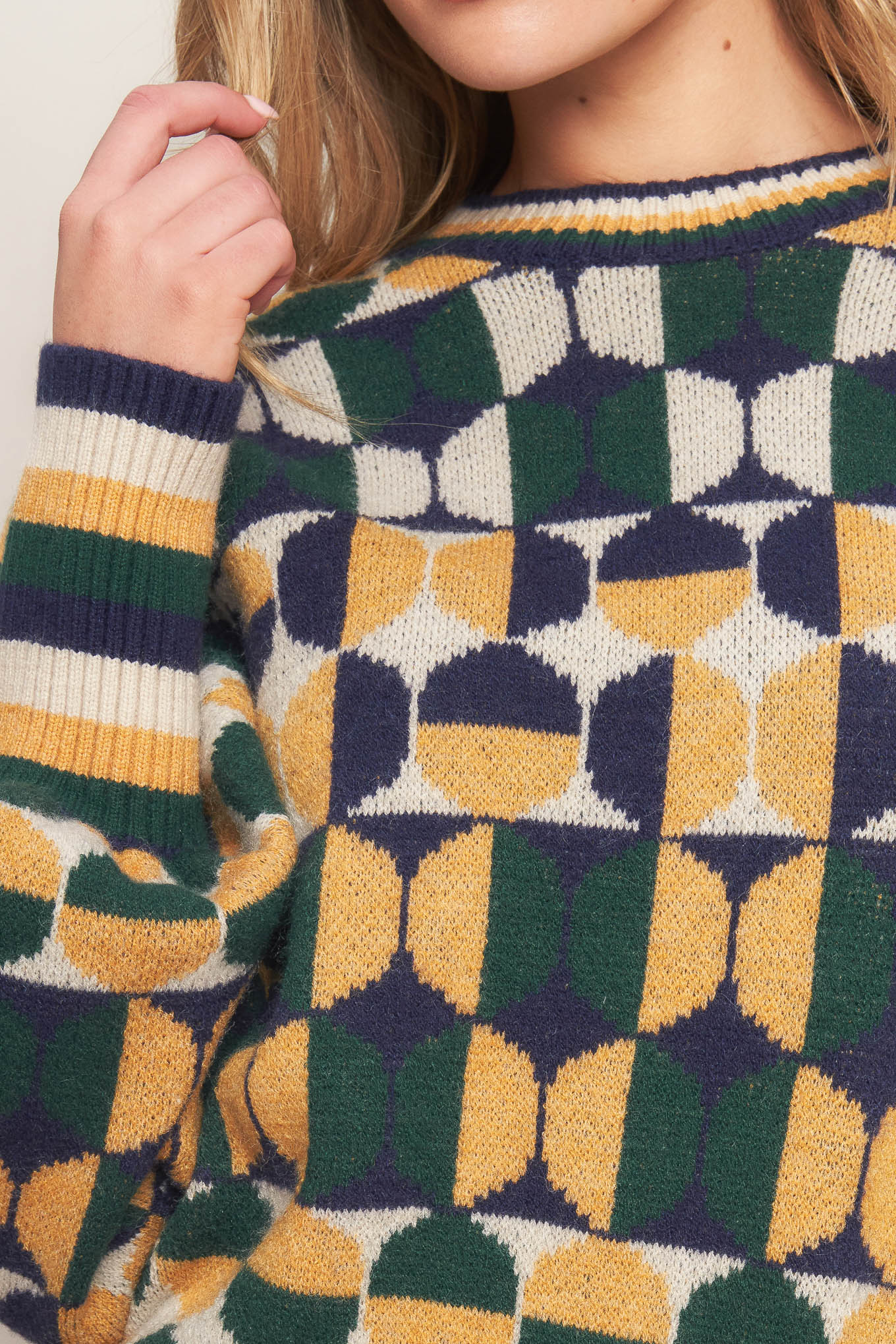 A jacquard knit sweater with a high neckline and long-sleeve