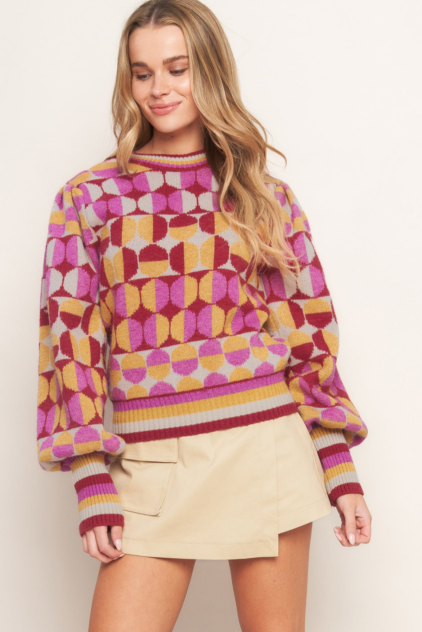A jacquard knit sweater with a high neckline and long-sleeve