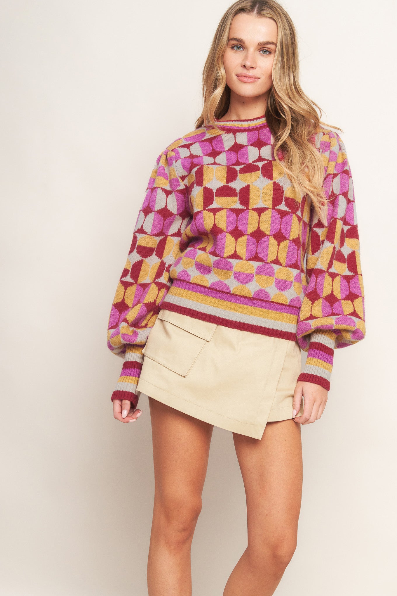 A jacquard knit sweater with a high neckline and long-sleeve