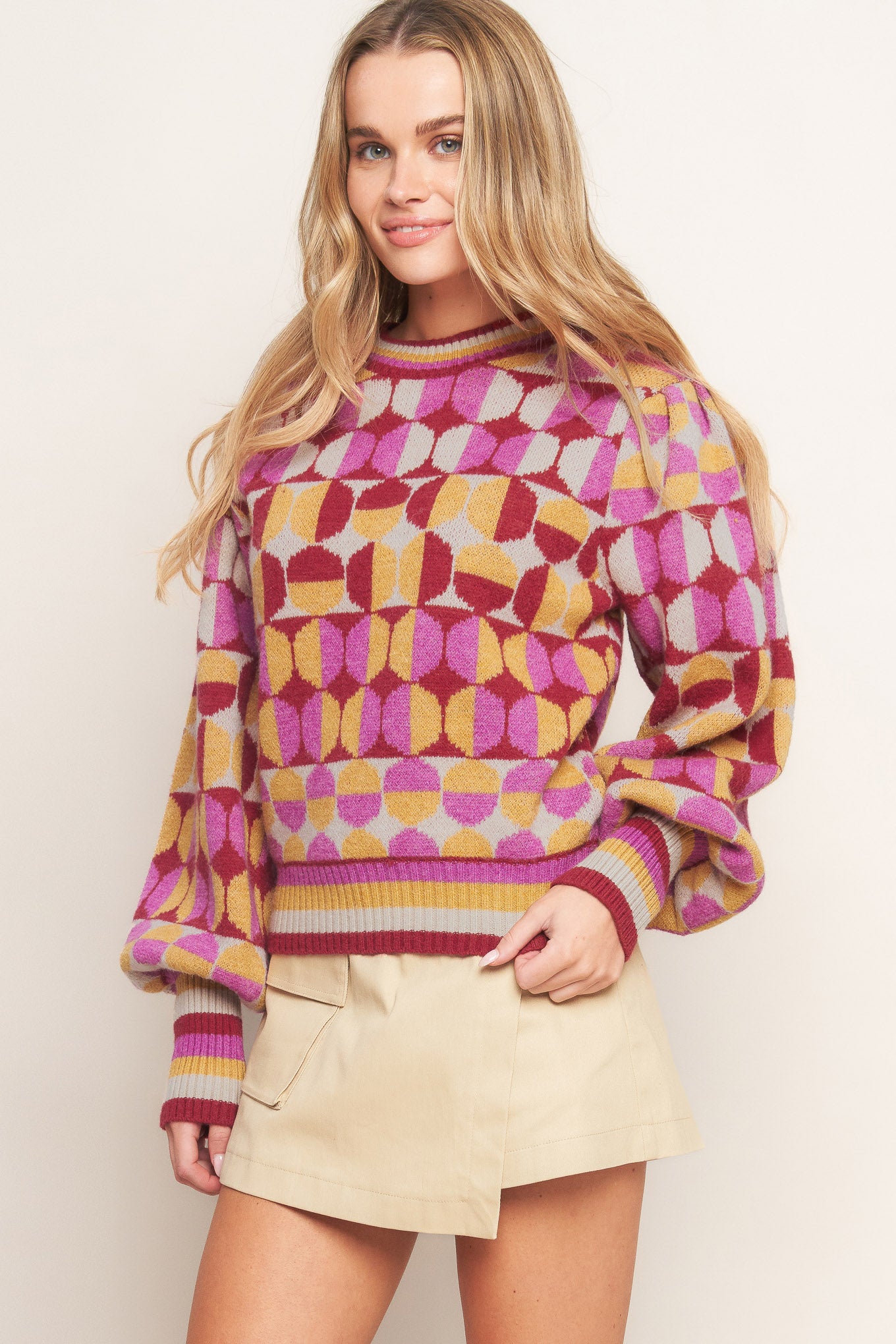 A jacquard knit sweater with a high neckline and long-sleeve