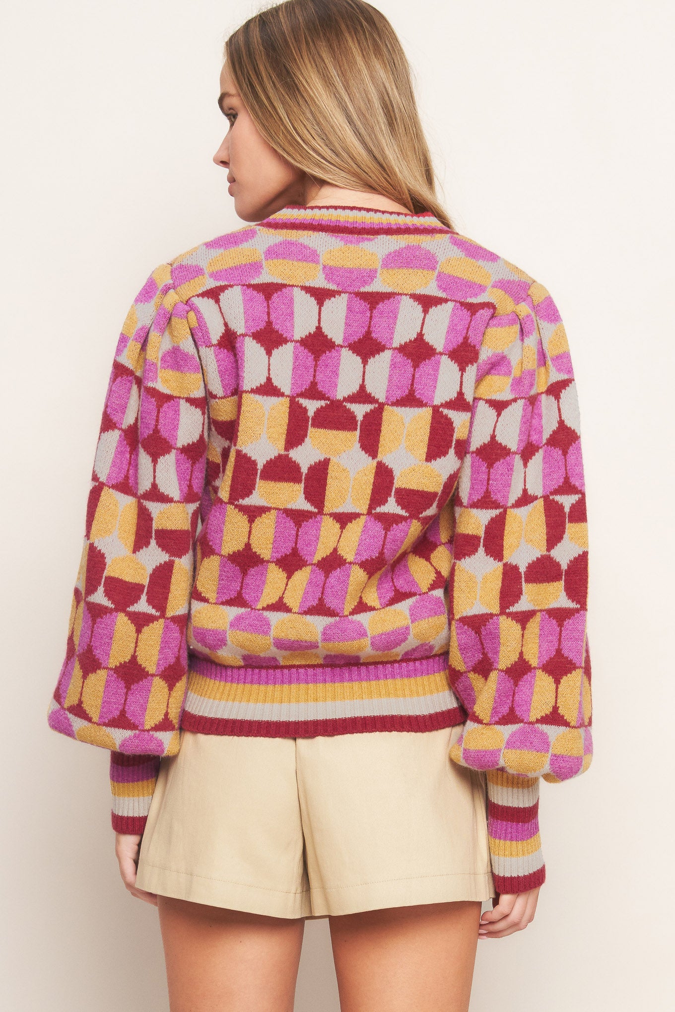 A jacquard knit sweater with a high neckline and long-sleeve