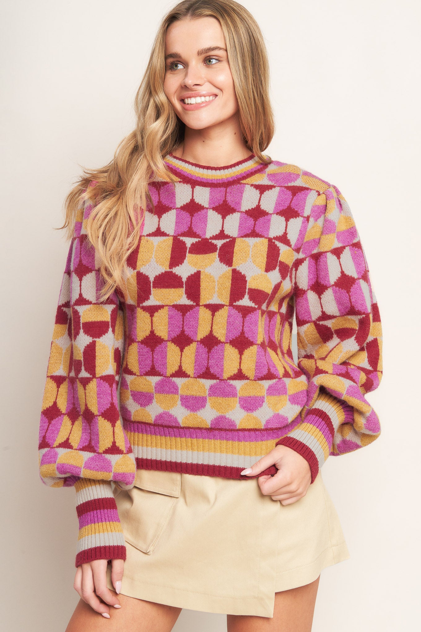 A jacquard knit sweater with a high neckline and long-sleeve