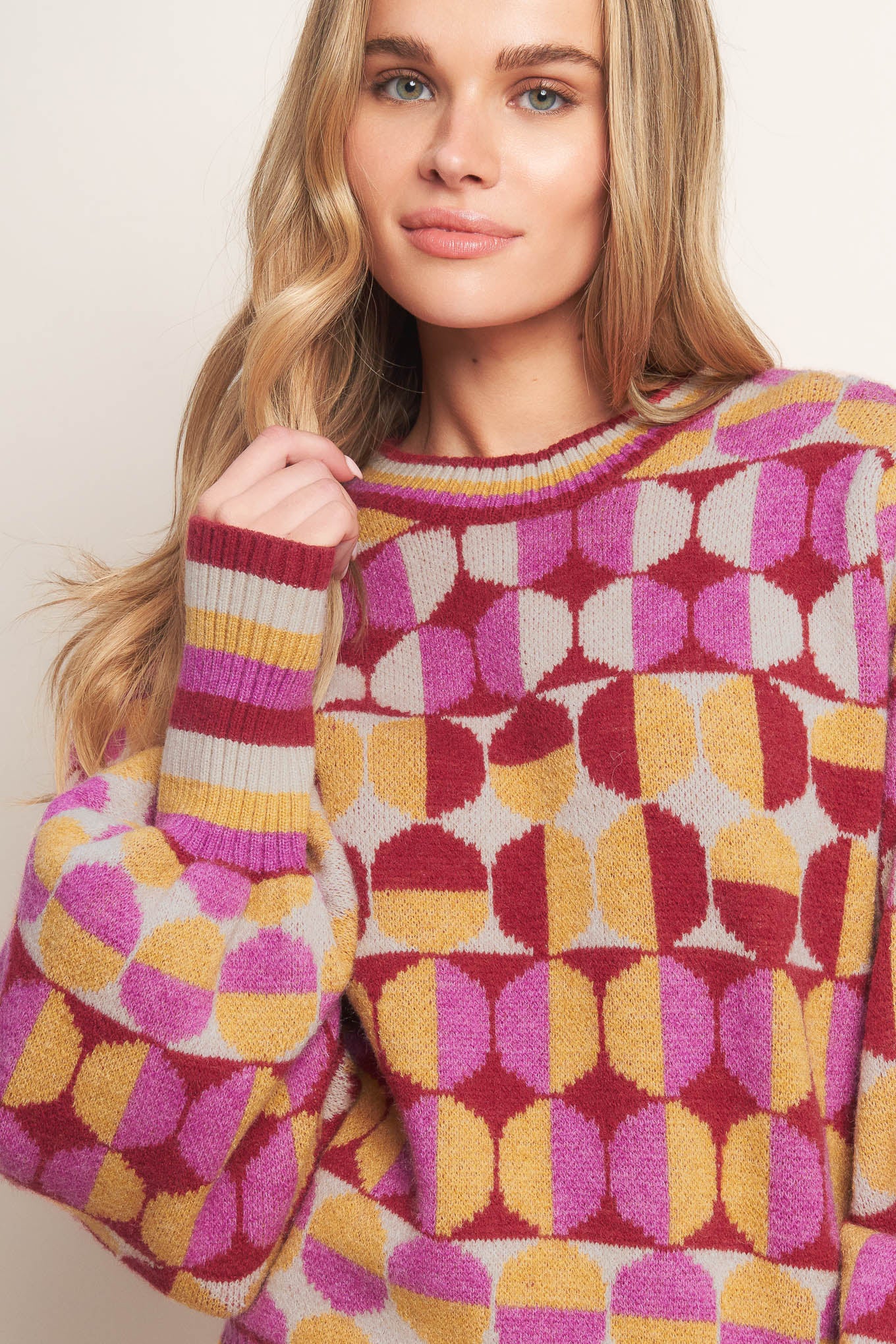 A jacquard knit sweater with a high neckline and long-sleeve
