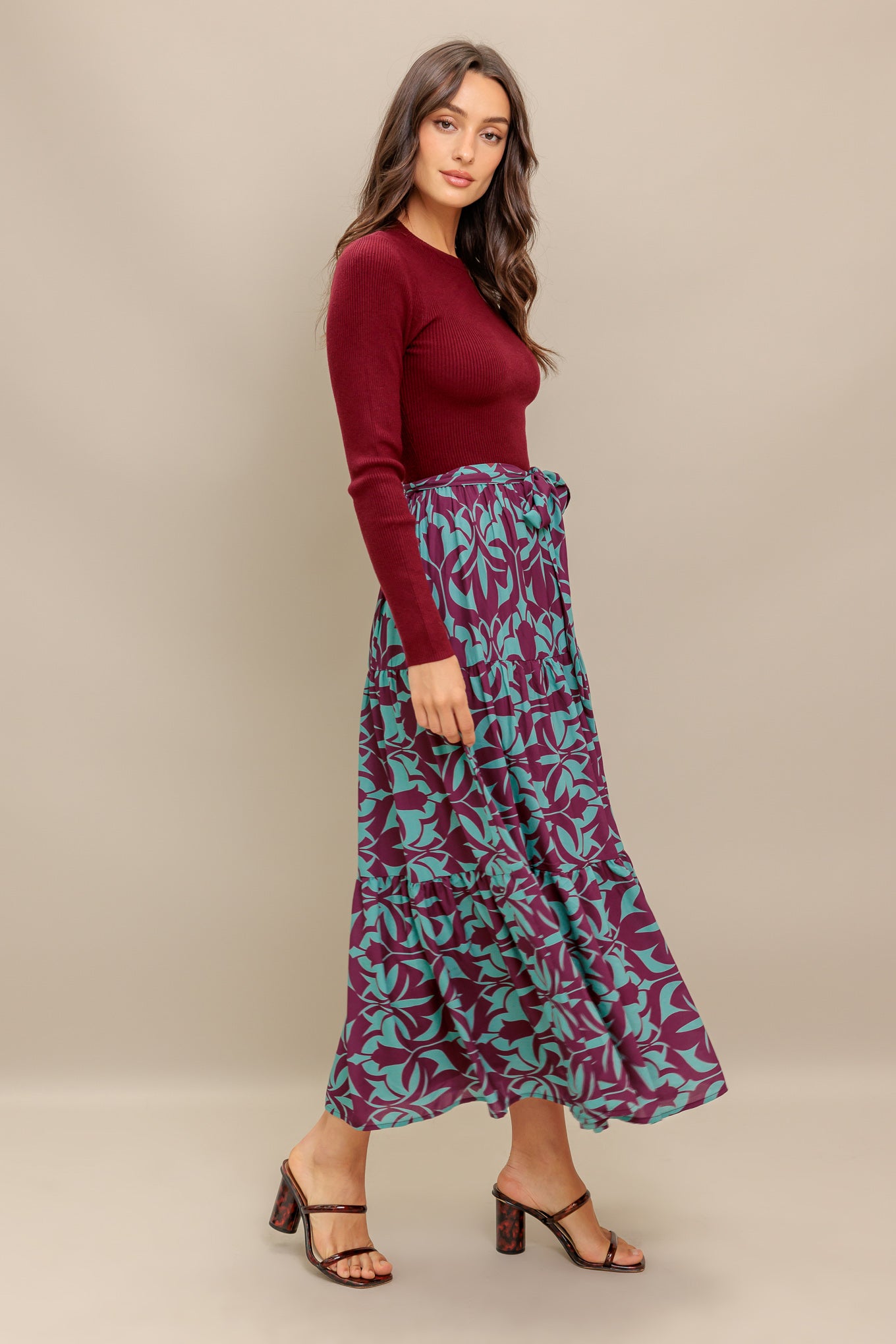A sweater knit top and printed woven midi dress featuring round neckline, long sleeve and tiered skirt with sash tie