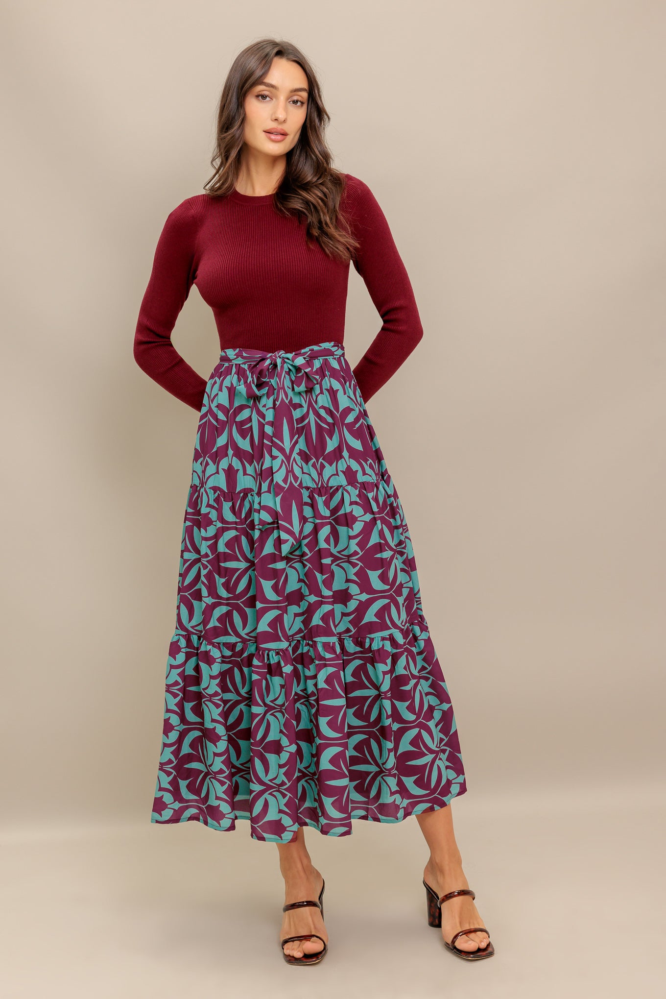 A sweater knit top and printed woven midi dress featuring round neckline, long sleeve and tiered skirt with sash tie