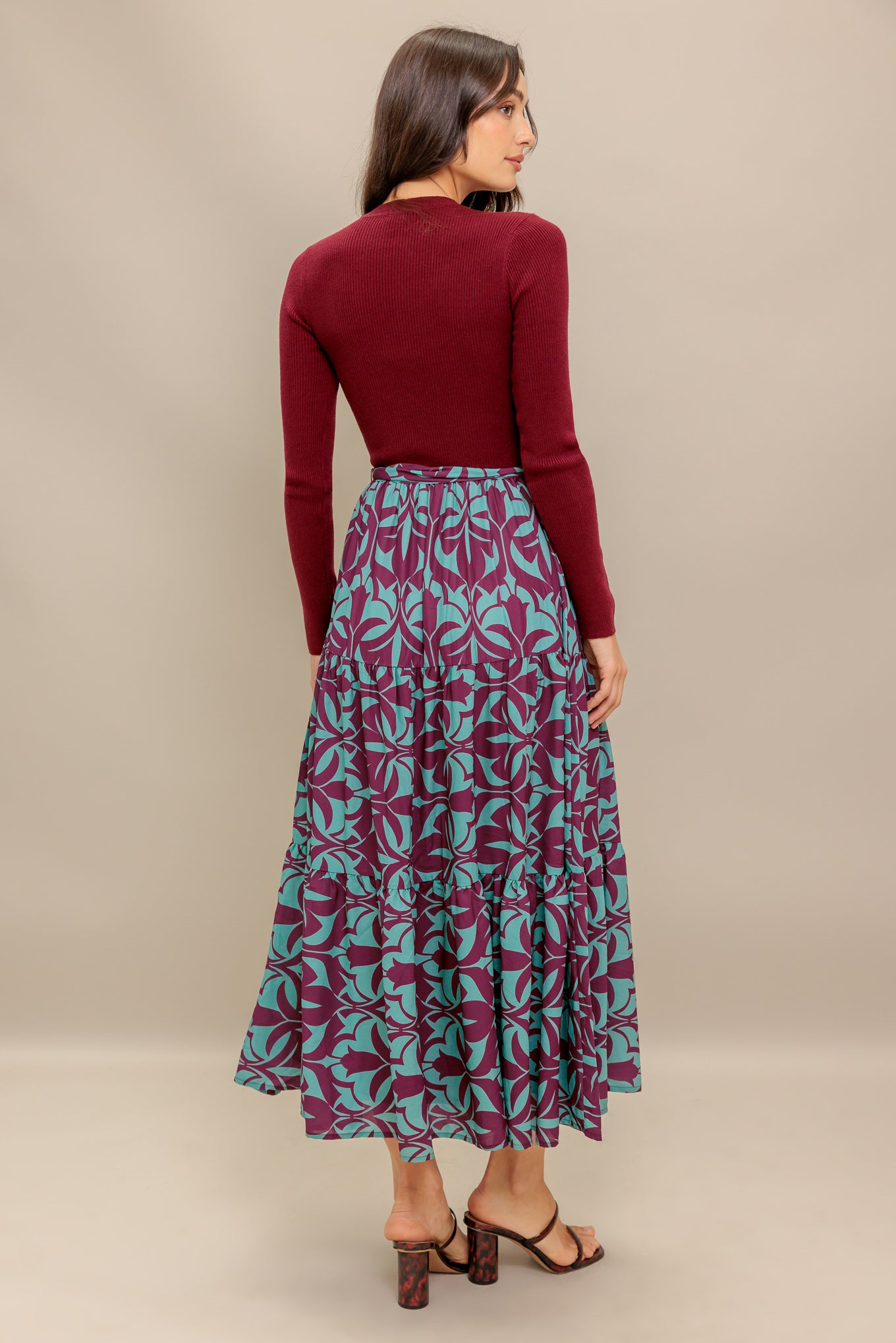 A sweater knit top and printed woven midi dress featuring round neckline, long sleeve and tiered skirt with sash tie