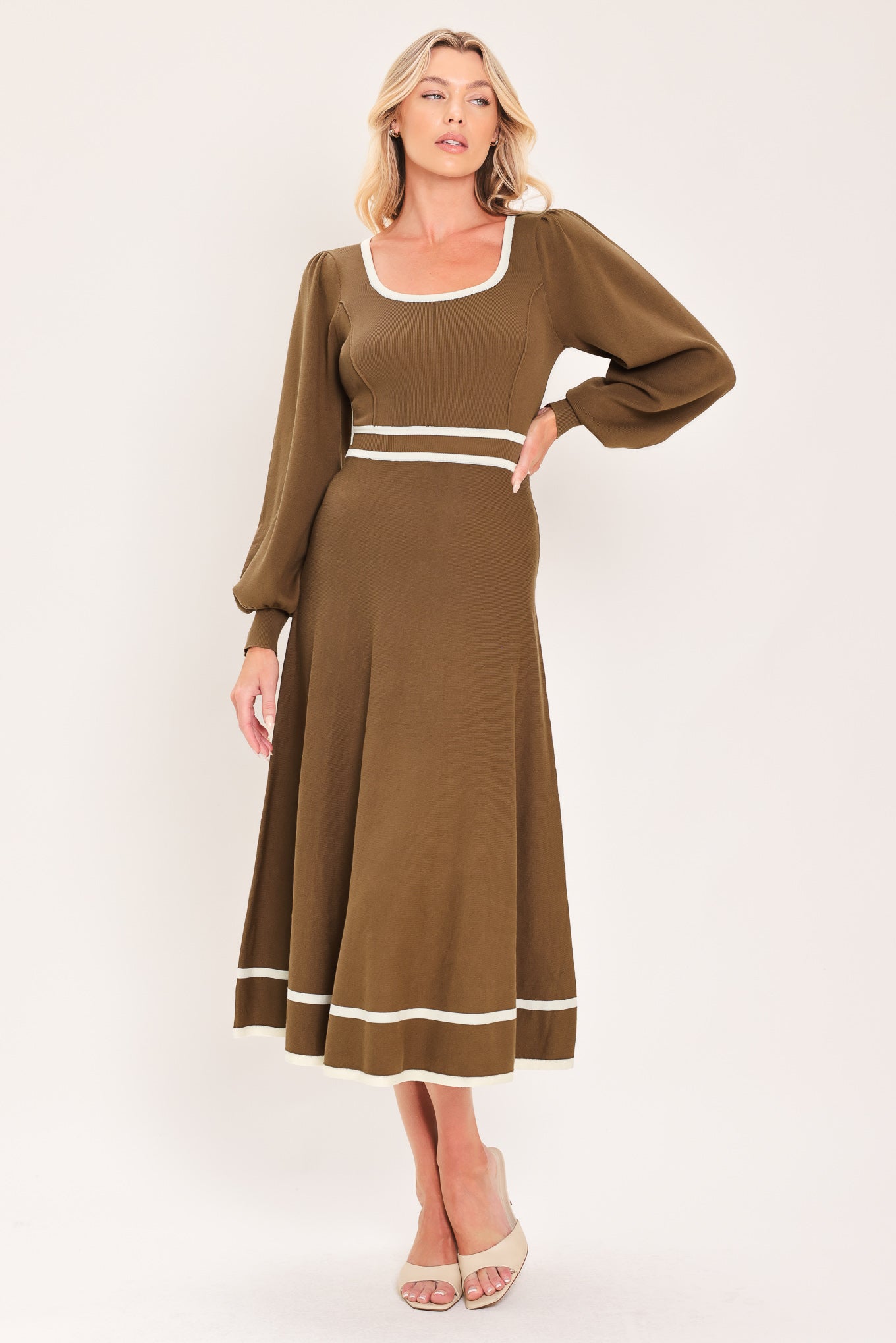 A woman modeling a brown midi dress with white trim details, including a square neckline, sleeve cuffs, a horizontal waist stripe, and a hemline | Flying tomato