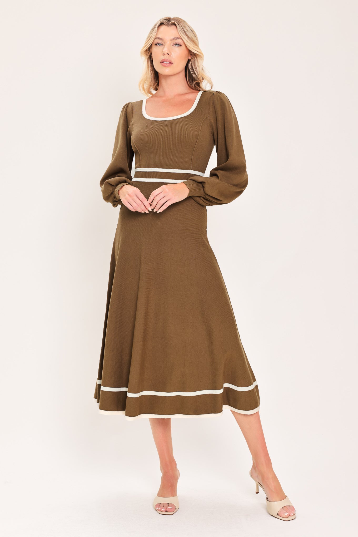 A woman modeling a brown midi dress with white trim details, including a square neckline, sleeve cuffs, a horizontal waist stripe, and a hemline | Flying tomato
