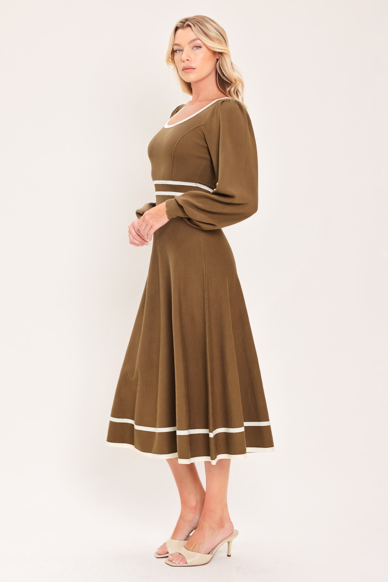 A woman modeling a brown midi dress with white trim details, including a square neckline, sleeve cuffs, a horizontal waist stripe, and a hemline | Flying tomato