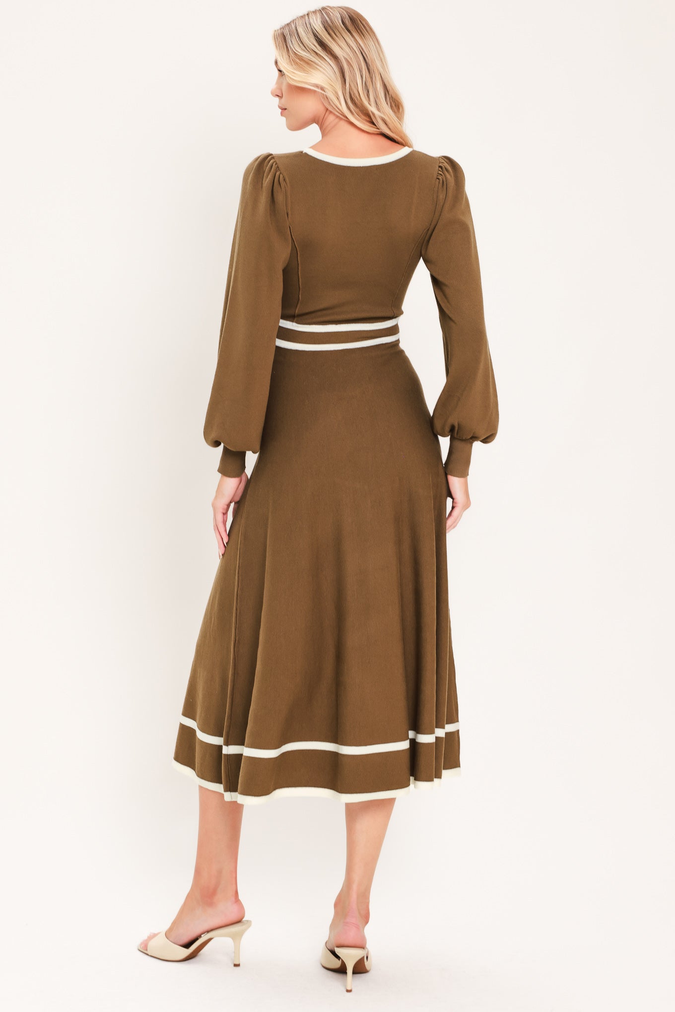 A woman modeling a brown midi dress with white trim details, including a square neckline, sleeve cuffs, a horizontal waist stripe, and a hemline | Flying tomato
