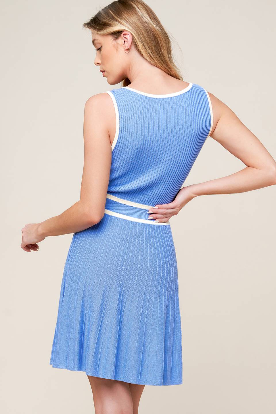 A blue sweater knit mini dress featuring U neckline, sleeveless and A line skirt.