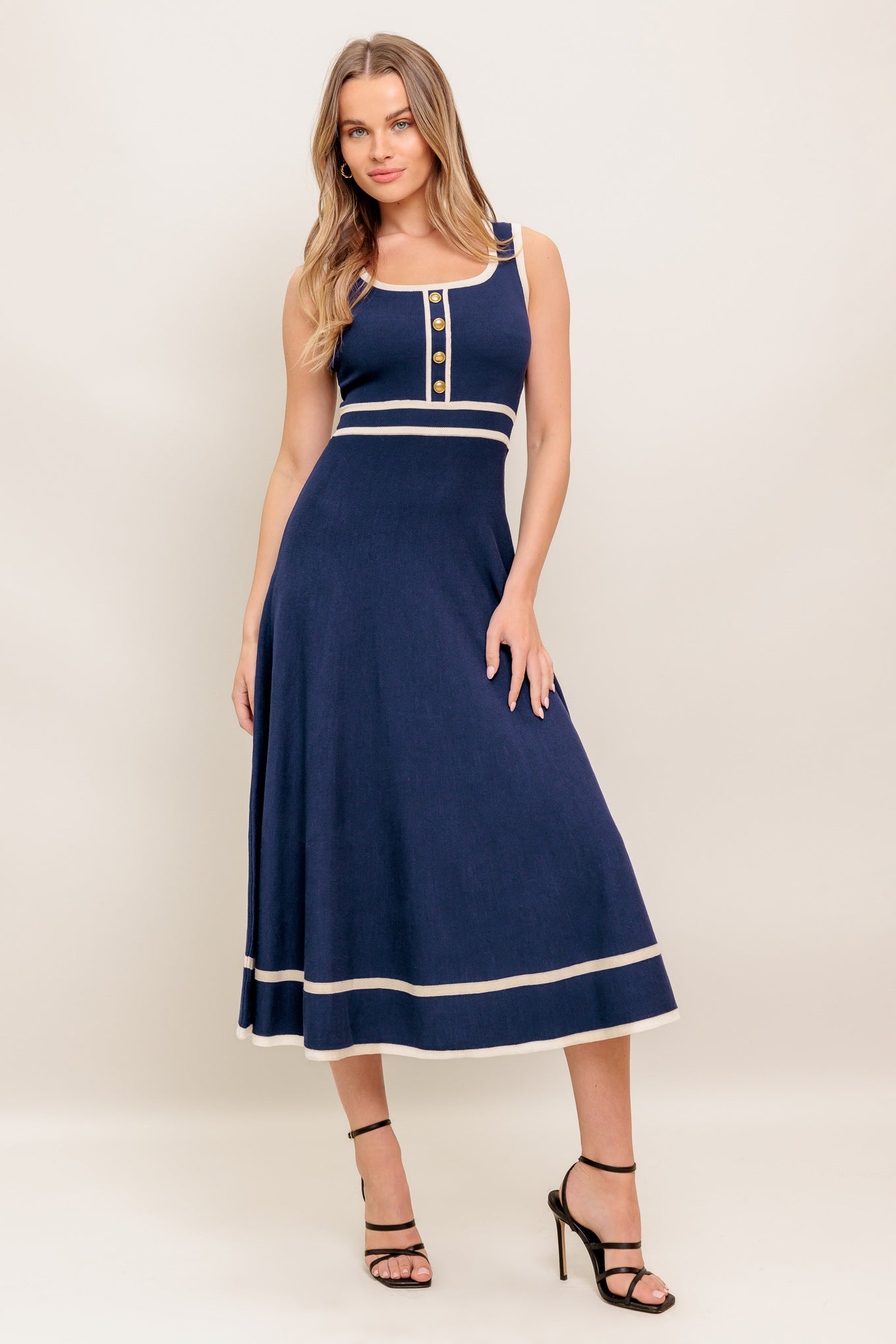 A sweater knit midi dress featuring square neckline, sleeveless, front button detail and circle skirt