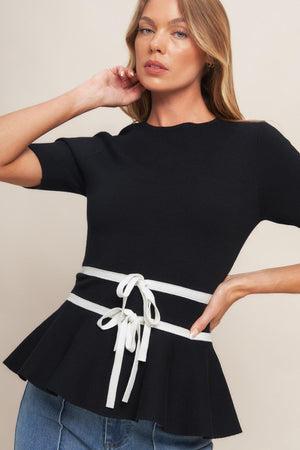 A solid sweater knit top featuring round neckline, short sleeve, bow front, peplum and back zipper closure