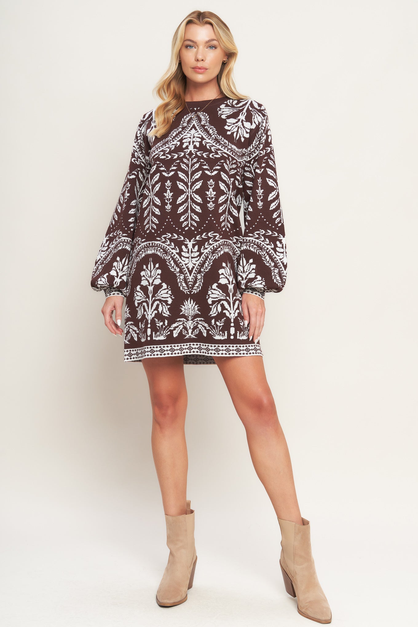 A sweater knit mini dress featuring crew neckline and long blouson sleeve