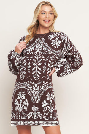 A sweater knit mini dress featuring crew neckline and long blouson sleeve