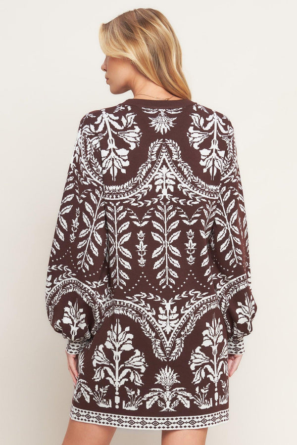 A sweater knit mini dress featuring crew neckline and long blouson sleeve