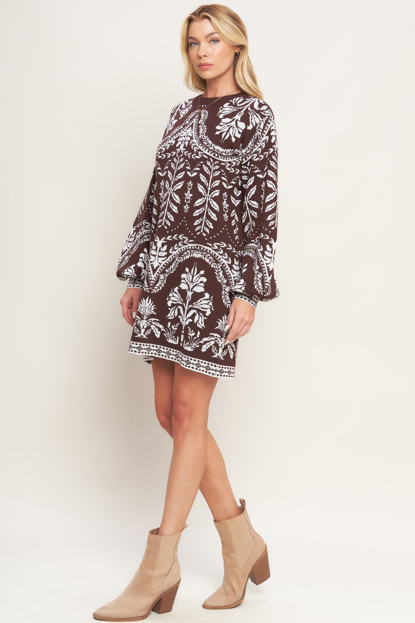 A sweater knit mini dress featuring crew neckline and long blouson sleeve