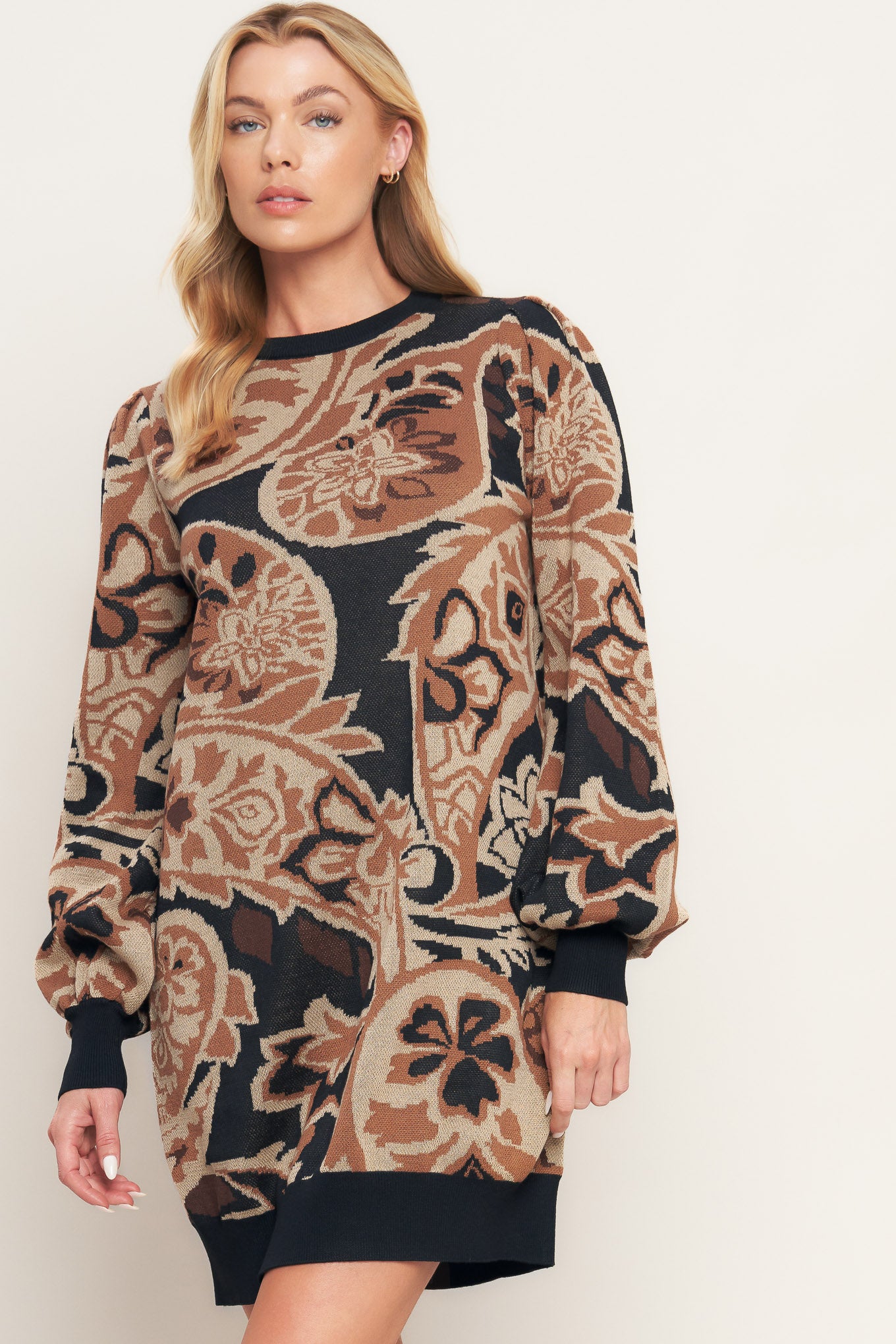 A sweater knit mini dress featuring crew neckline and long blouson sleeve