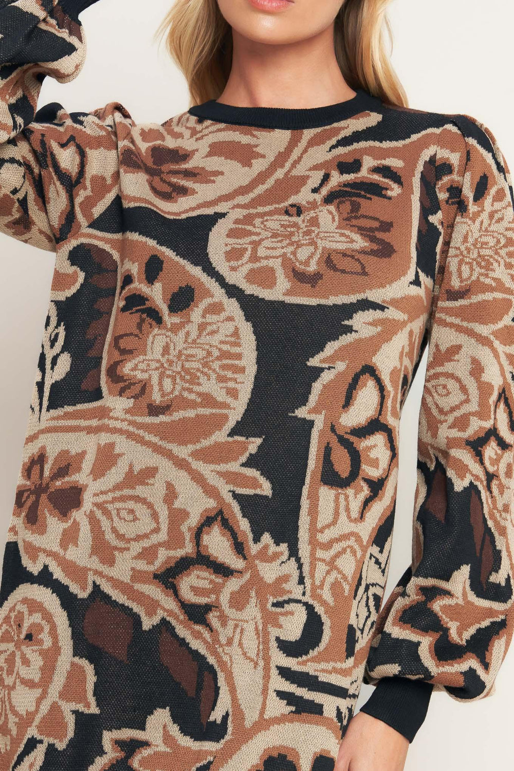 A sweater knit mini dress featuring crew neckline and long blouson sleeve