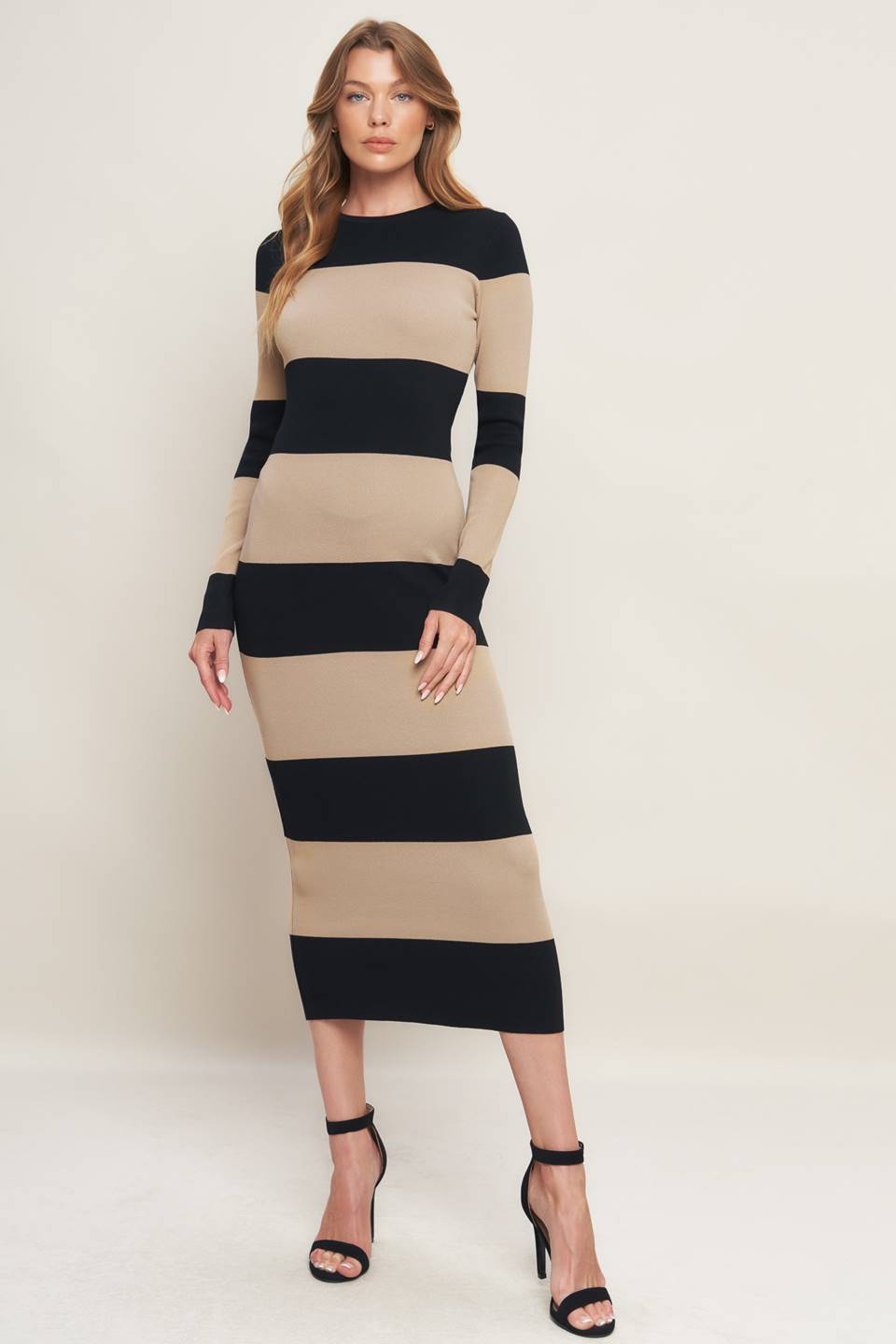 
Woman wearing a black and beige long sleeve striped midi dress | Flying Tomato
