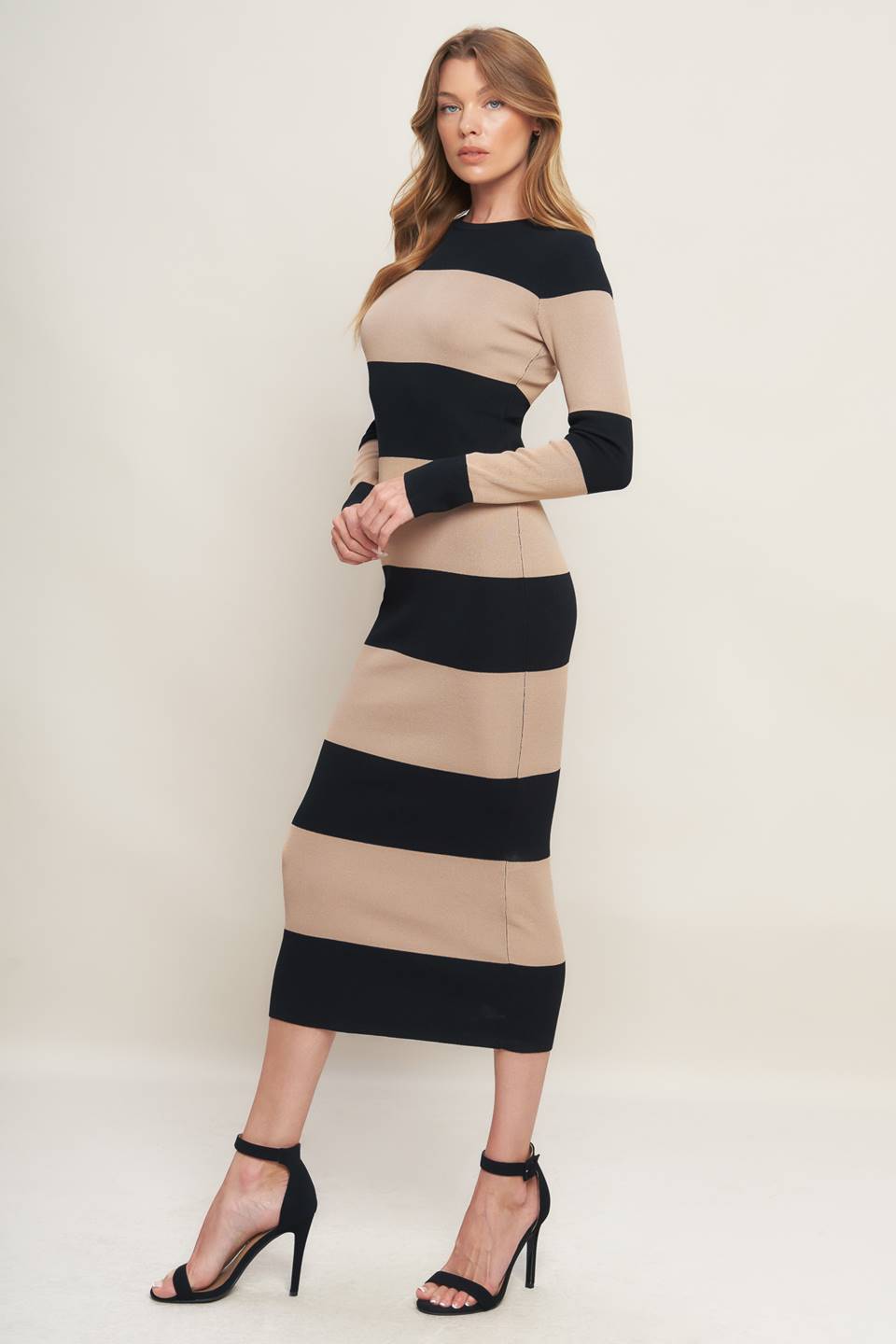 Woman wearing a black and beige long sleeve striped midi dress | Flying Tomato