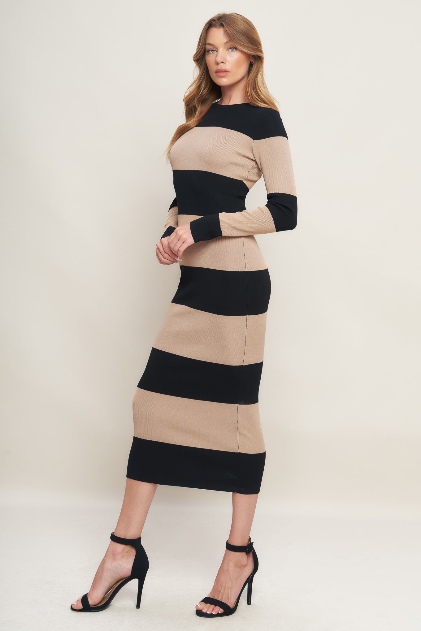 A sweater knit midi dress featuring round neckline and long sleeve
