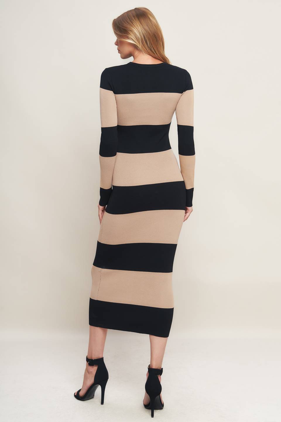 Woman wearing a black and beige long sleeve striped midi dress | Flying Tomato
