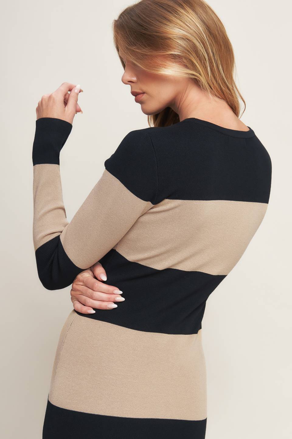 Woman wearing a black and beige long sleeve striped midi dress | Flying Tomato