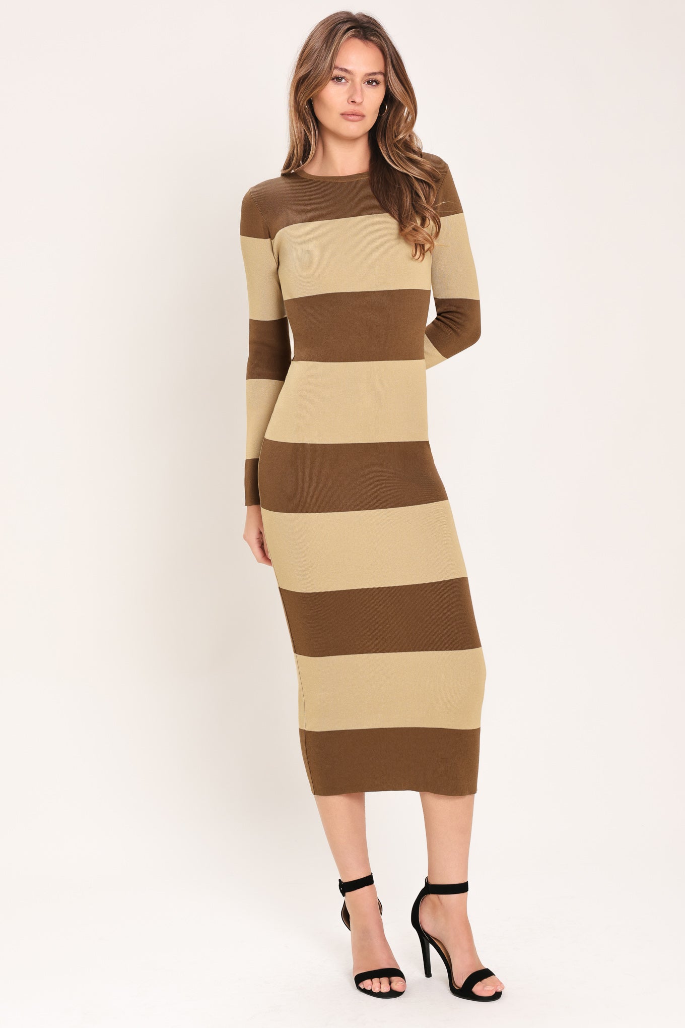 Woman wearing a brown and beige long sleeve striped midi dress | Flying Tomato