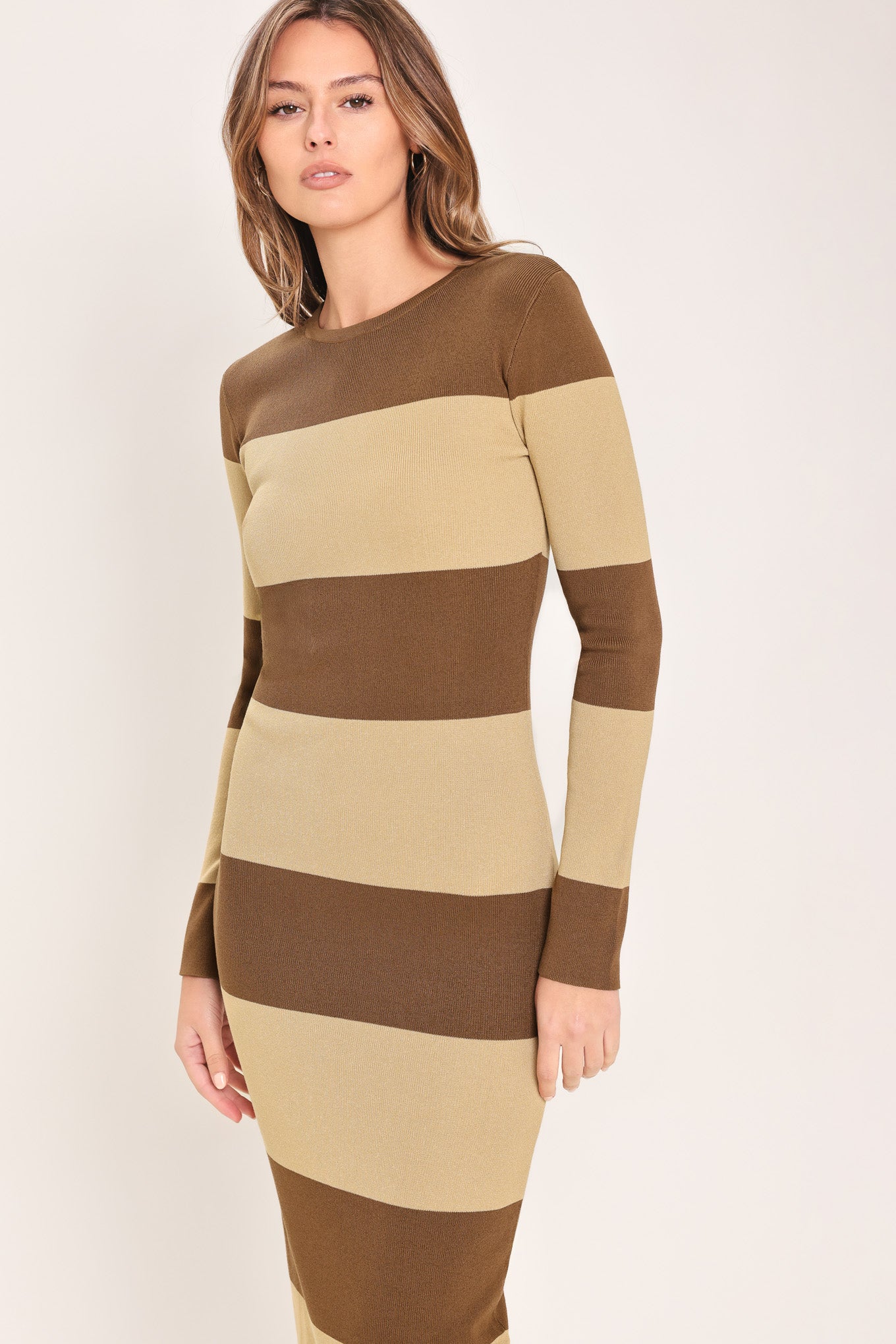 
Woman wearing a brown and beige long sleeve striped midi dress | Flying Tomato
