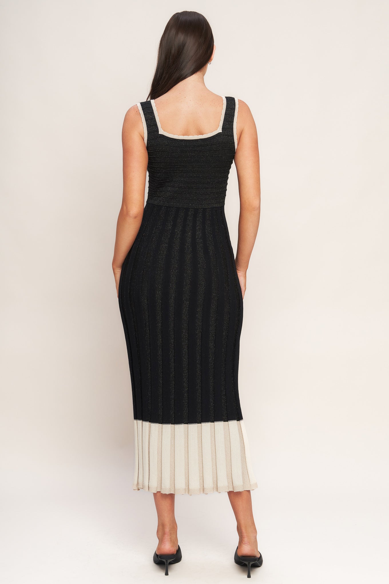 A sweater knit midi dress featuring square neckline, sleeveless and body contouring