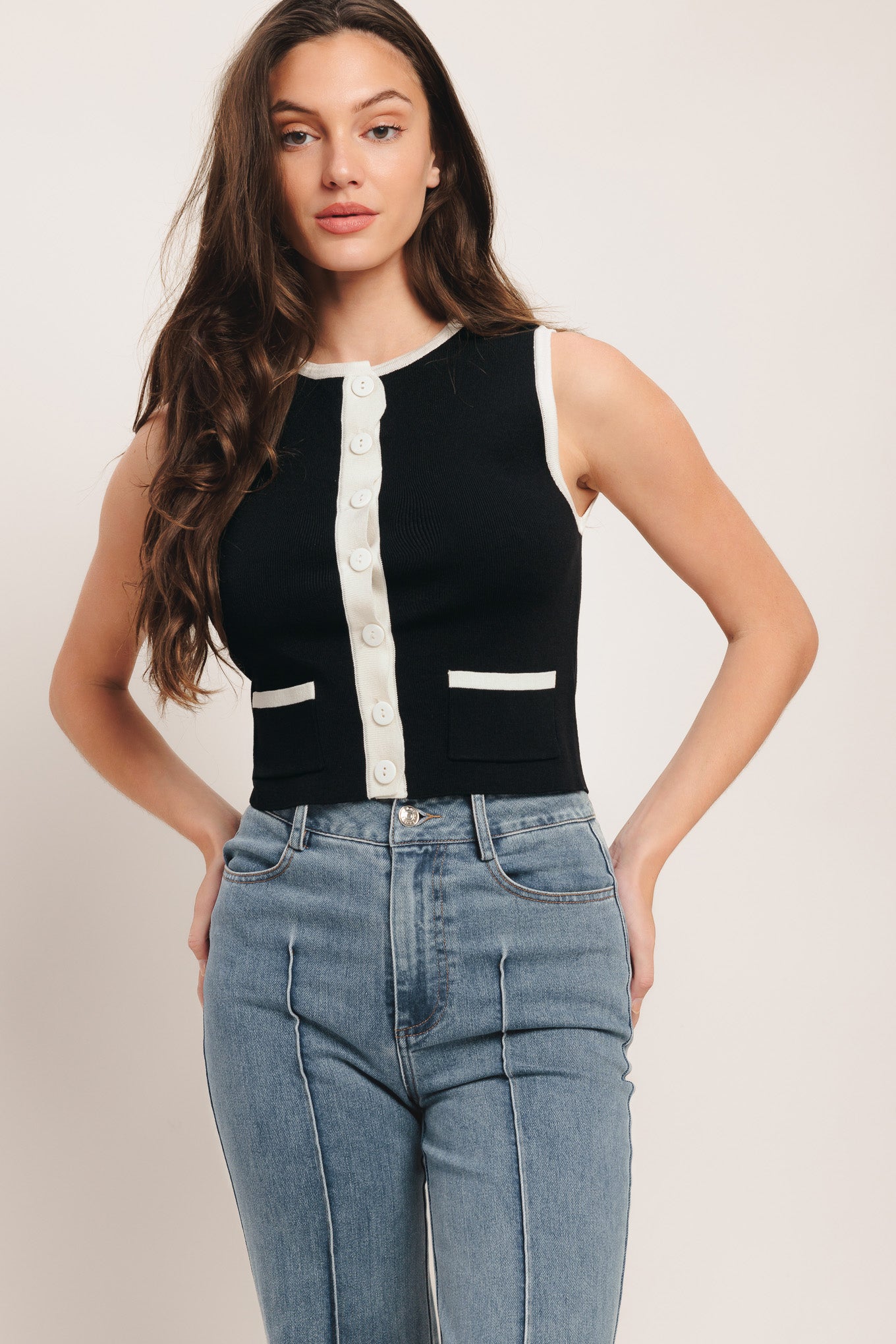 A color blocked sweater knit top with round neckline, sleeveless, front pockets and button down

Details:

Self: 78% Viscose 22% Nylon

Size & Fit

-Model is 58 And Wearing Size Small
-Measurements Taken From Size Small
-Approx. Length: 18"