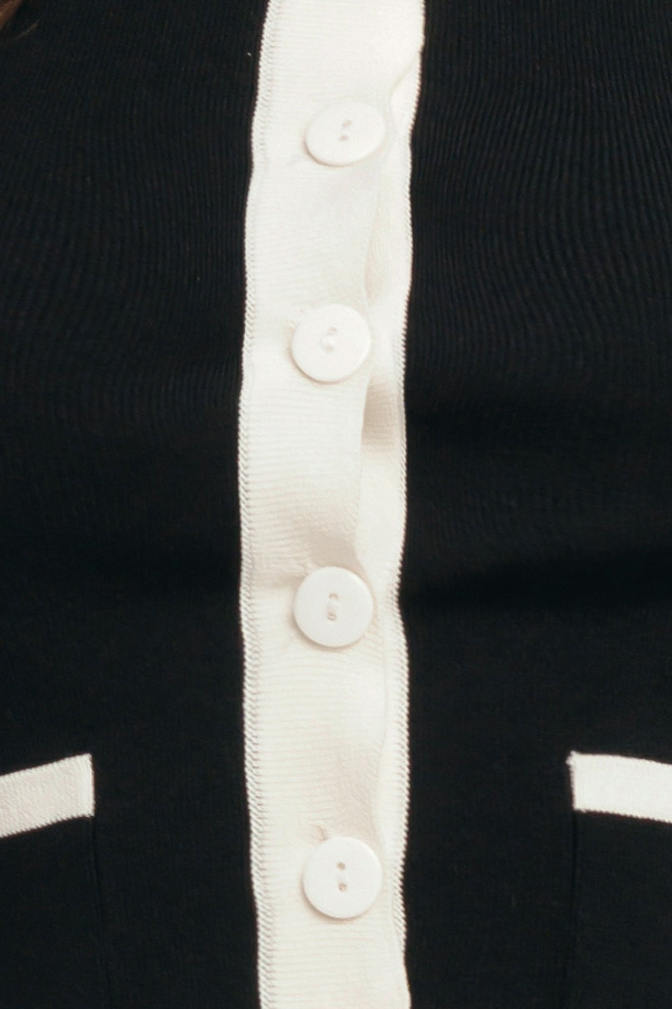 A color blocked sweater knit top with round neckline, sleeveless, front pockets and button down

Details:

Self: 78% Viscose 22% Nylon

Size & Fit

-Model is 58 And Wearing Size Small
-Measurements Taken From Size Small
-Approx. Length: 18"