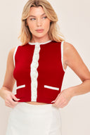Woman wearing a sleeveless red and white color blocked sweater knit top top with white buttons | Flying Tomato