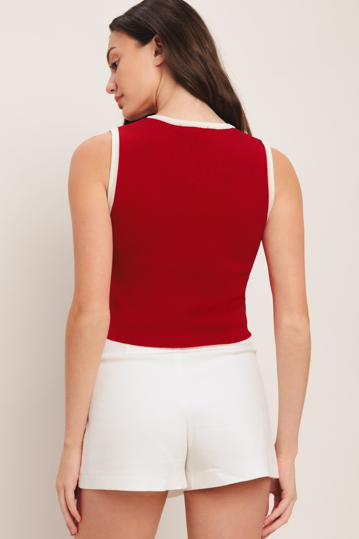 A color blocked sweater knit top with round neckline, sleeveless, front pockets and button down

Details:

Self: 78% Viscose 22% Nylon

Size & Fit

-Model is 58 And Wearing Size Small
-Measurements Taken From Size Small
-Approx. Length: 18"