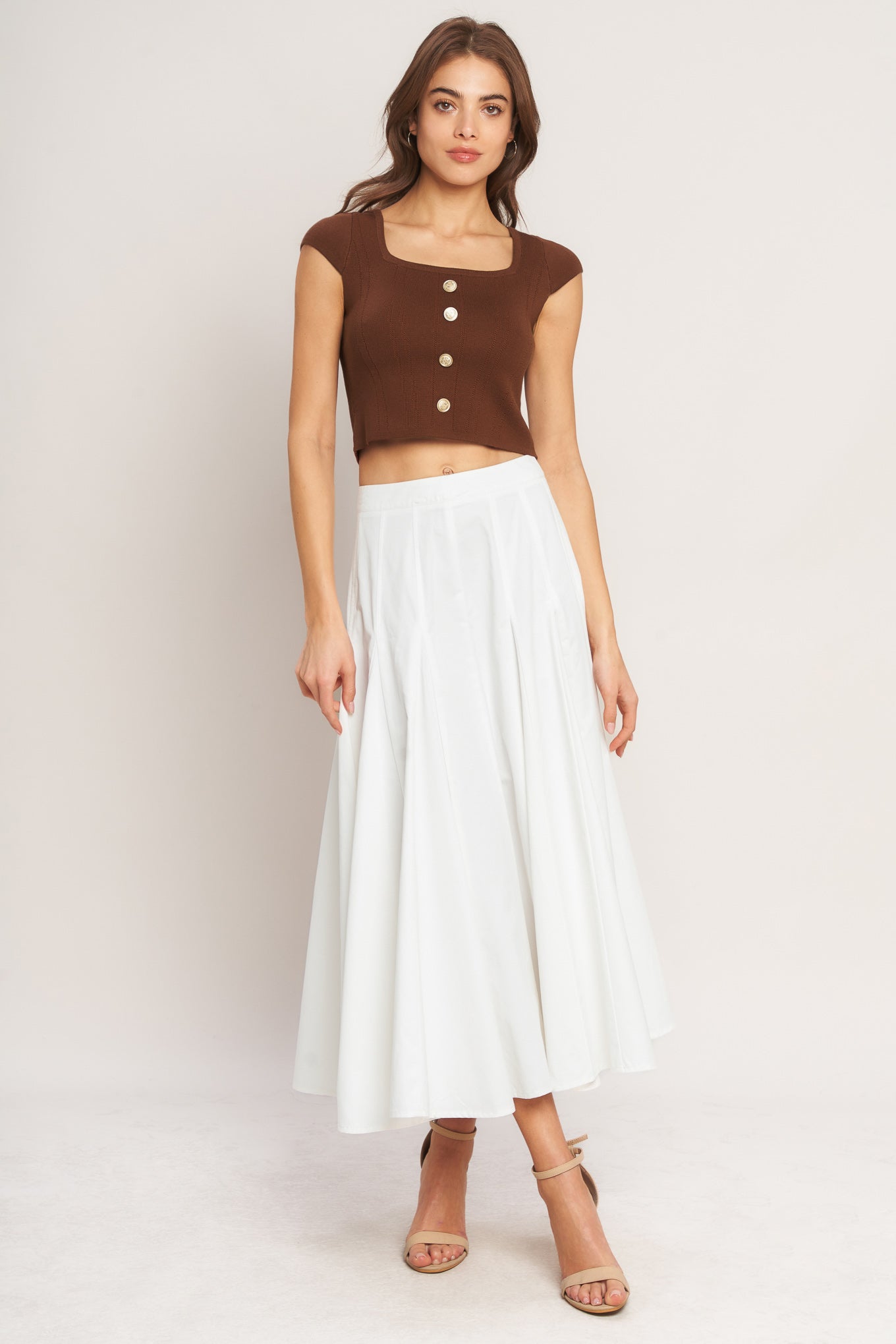 A brown sweater knit top featuring square neckline, cap sleeve and front button detail