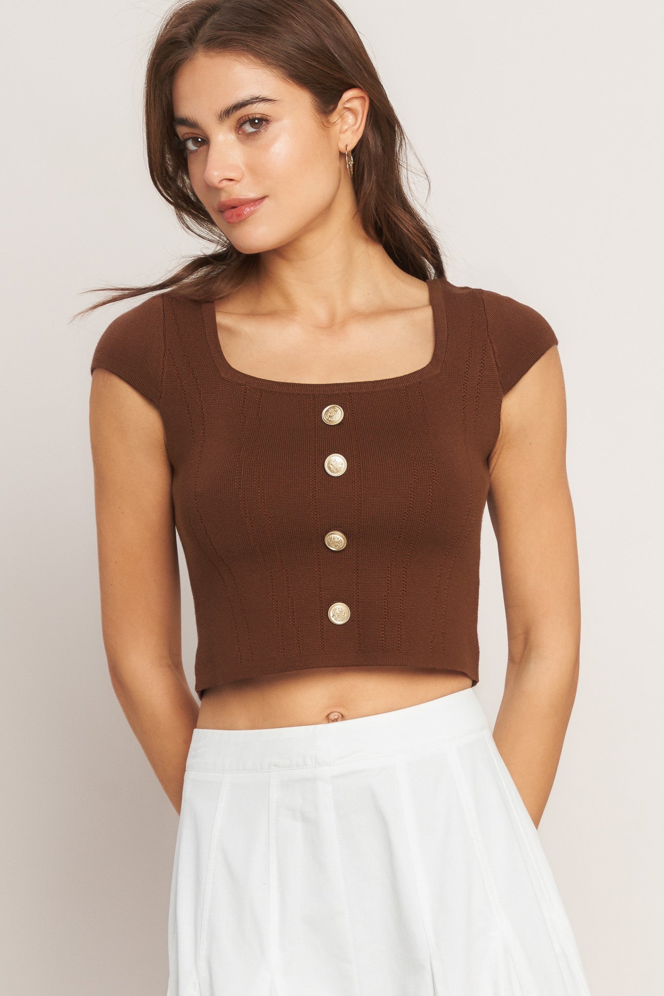 A brown sweater knit top featuring square neckline, cap sleeve and front button detail