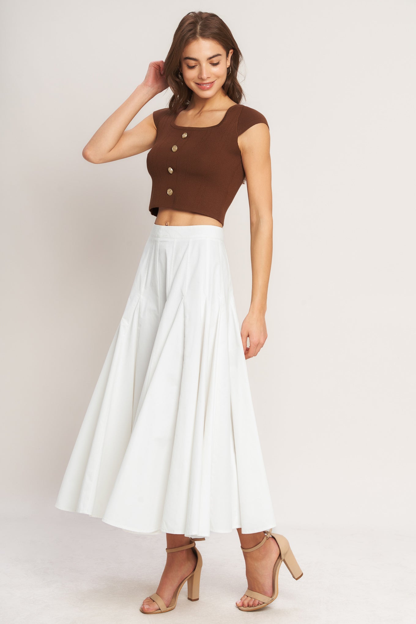 A brown sweater knit top featuring square neckline, cap sleeve and front button detail