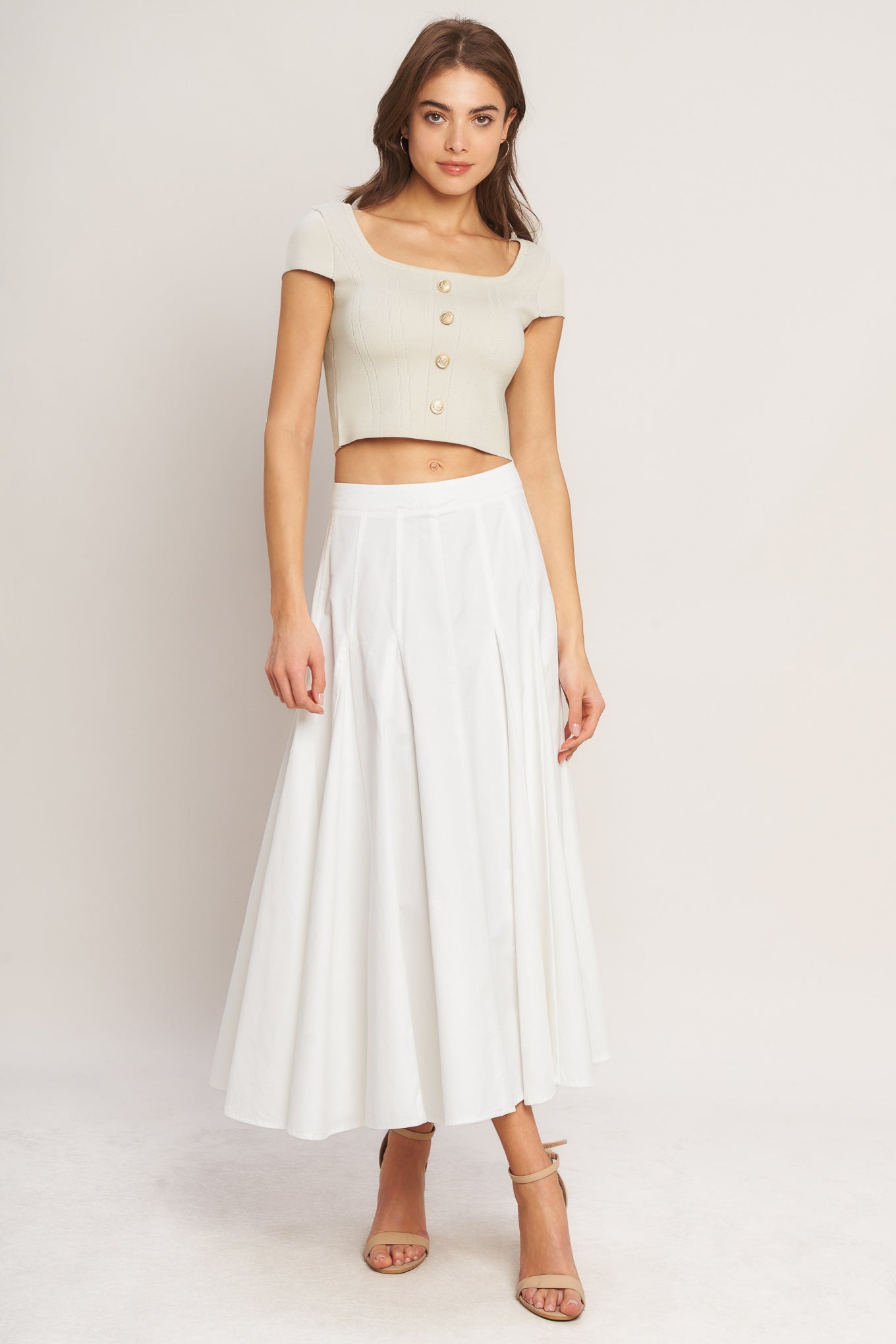 A sweater knit top featuring square neckline, cap sleeve and front button detail