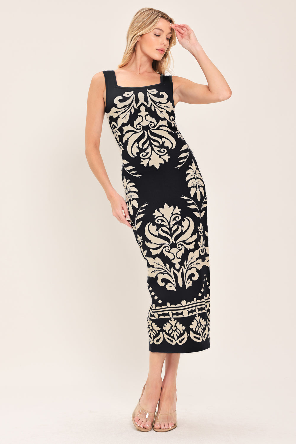 Woman wearing a blue and beige sleeveless floral jacquard sweater knit midi dress with square neckline | Flying Tomato
