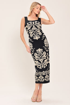 Woman wearing a black and beige sleeveless floral jacquard sweater knit midi dress with square neckline | Flying Tomato