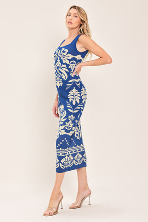 Woman wearing a blue and beige sleeveless floral jacquard sweater knit midi dress with square neckline | Flying Tomato