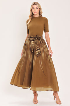 A woman modeling a brown midi dress with a short-sleeve mock neck top, pleated skirt, and a matching fabric tie belt | Flying Tomato