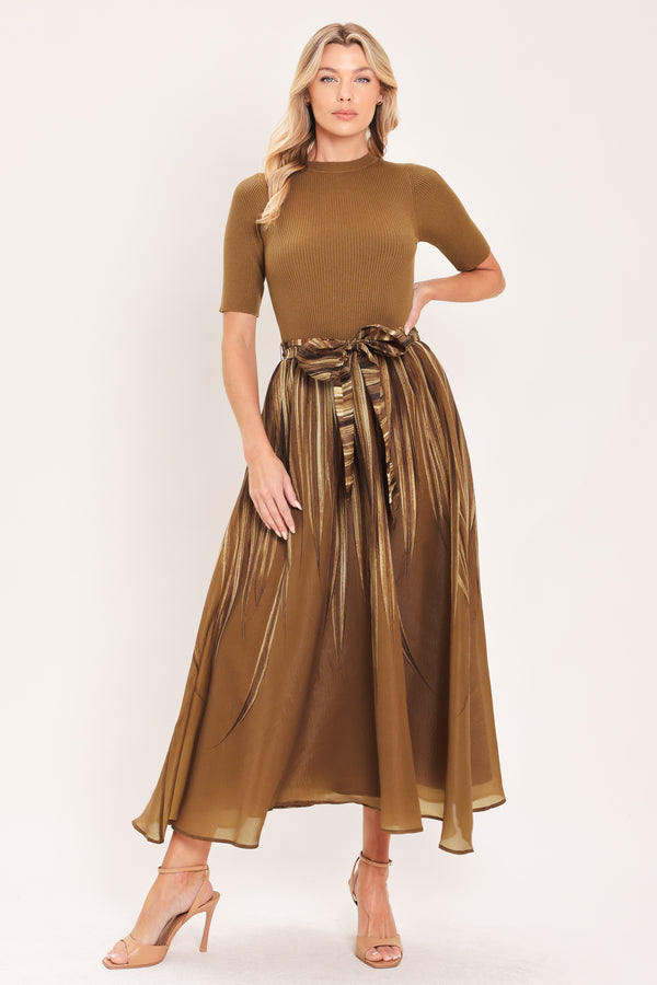 A woman modeling a brown midi dress with a short-sleeve mock neck top, pleated skirt, and a matching fabric tie belt | Flying Tomato