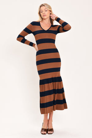 A woman modeling a long-sleeve ribbed knit midi dress with horizontal brown and navy and rust stripes, featuring a V-neckline and a flared mermaid-style hem | Flying Tomato