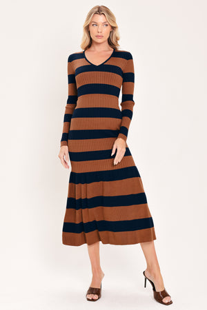 A woman modeling a long-sleeve ribbed knit midi dress with horizontal brown and navy and rust stripes, featuring a V-neckline and a flared mermaid-style hem | Flying Tomato